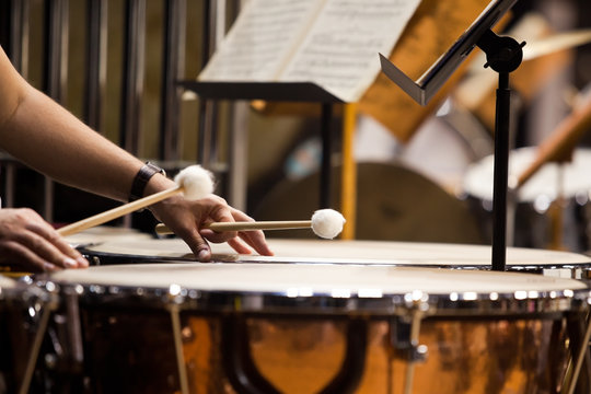 Hands musician playing the timpani in the orchestra closeup