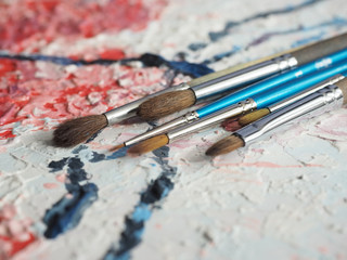 Fototapeta premium Paintbrushes on oil painting canvas