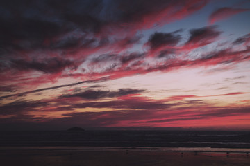 Fototapeta na wymiar Colourful sunset over the beach at Polzeath Vintage Retro Filter