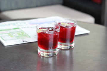 Splash in a glass of red lemonade isolated on white background