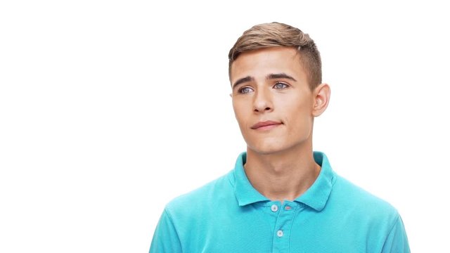 Young handsome man dreaming smiling over white background Slow motion