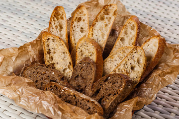 black bread and white bread on kraft paper on the table