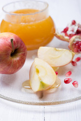 Pieces ripe pomegranate, honey and apple