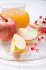 Pieces ripe pomegranate, honey and apple