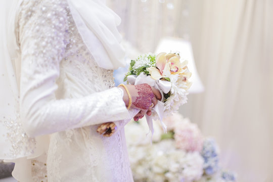 Bride with bouquet of flowers. Close up.