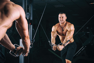Fototapeta na wymiar Bodybuider demonstrate crossover exercises in the gym.