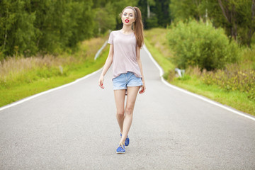 Portrait of young brunette woman in blue jeans short