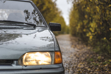 Obraz premium the car rides on sand road at sunset over hills in Russia