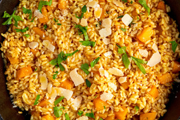 Pumpkin risotto in iron pan with Parmesan cheese. top view