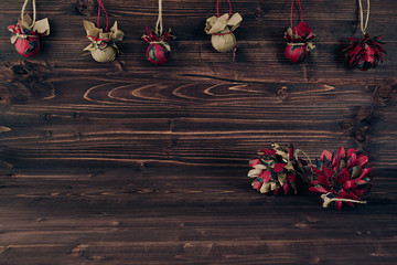 Christmas ornaments handmade on vintage brown wooden background. New Year background.