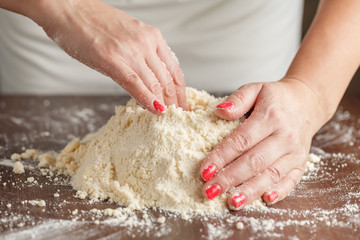 woman with lovely hands making home-made buttermilk biscuits usi