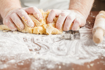 Pair of hands kneading dough