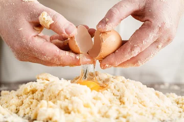 Foto auf Acrylglas person kneading dough on wooden table © Andrey Cherkasov