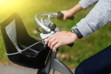 Obraz premium Man sitting on bicycle and holding wheel