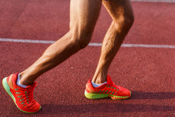 Male legs and feet on cross track outdoors