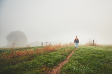 Fototapeta premium Lonely young man in mysterious fog