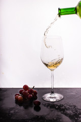 Flowing wine on white background and grape