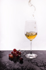 Flowing wine on white background and grape