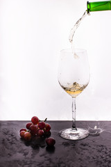 Flowing wine on white background and grape