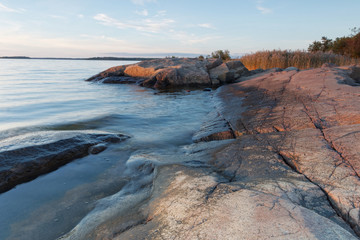 Cliffs, blue sea and horizon during sunset