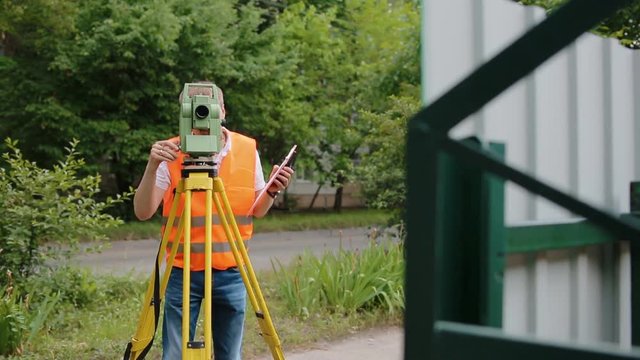 Surveyor at work measuring the distance