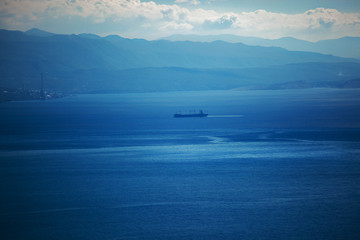 Large cargo ship sails away