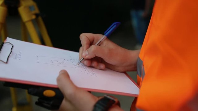 Surveyor makes plan of the land on the paper
