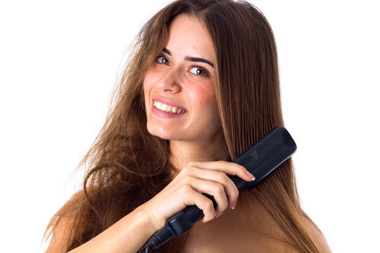 Woman Using Hair Straightener 