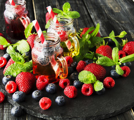 berry juice in a glass with berries, ice and mint