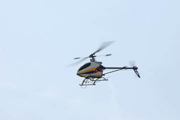 Fototapeta na wymiar Radio-controlled model helicopter in fligh