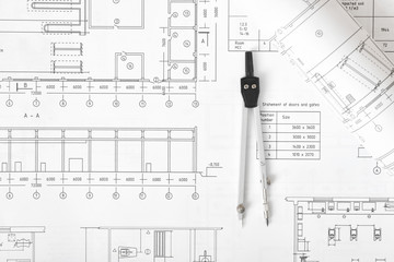 Engineering compass is on building plan.