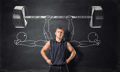 Athletic sportsman standing on the background with sketches of barbells and dumbbells.