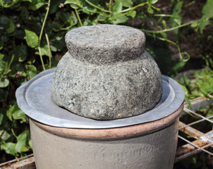 Obraz premium Granite mortar placed on the floor in the kitchen.