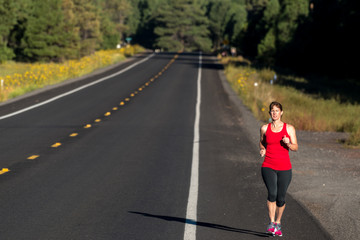 Female over forty running in countryside.