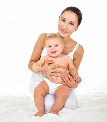 Mother and baby playing and smiling. Happy family.