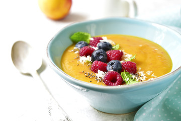 Peach smoothie  bowl on a light background.