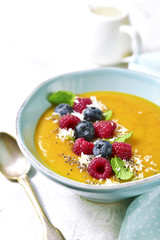 Peach smoothie  bowl on a light background.
