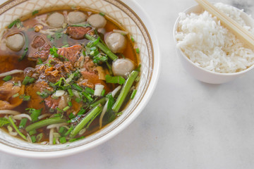 Chiness stew beef with meatball and a bowl of rice