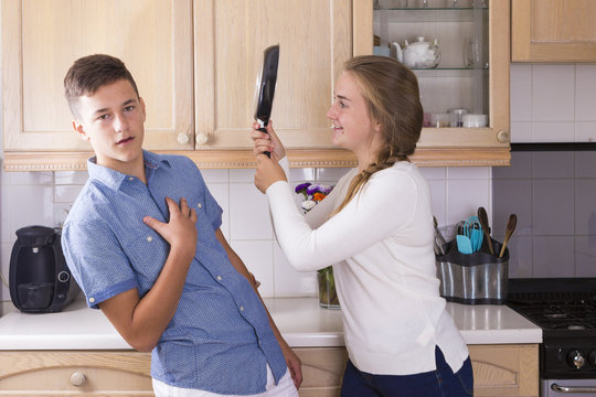 Teenage Siblings Having Fight In Kitchen