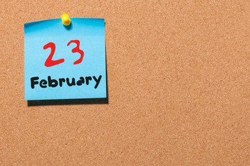 February 23rd. Day 23 of month, calendar on cork notice board background. Winter time. Empty space...