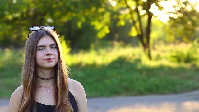Woman With Long Hair and Beautiful Eyes on a Green Background Shows the Different Human Emotions. Lady Portrays Apathy