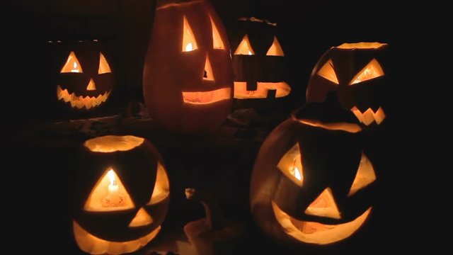 group of glowing pumpkins at night