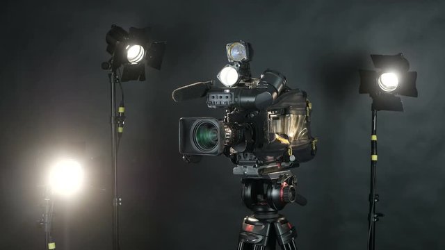 Professional broadcast camera at unrecognizable tv news studio. Isolated on background. 4K.