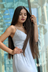 Girl in sundress walking on the street.