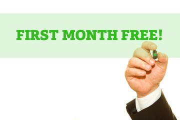 Businessman Hand Writing a message, First Month Free.