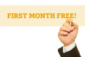 Businessman Hand Writing a message, First Month Free.