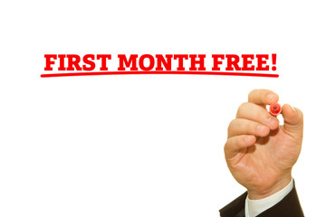 Businessman Hand Writing a message, First Month Free.