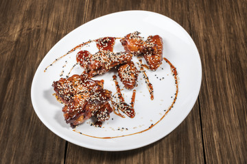 Plate of chicken wings on wooden table