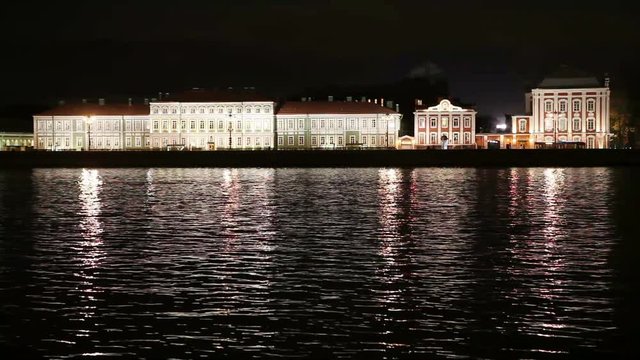 Night view of the University embankment of St. Petersburg through the Neva River- Peter and Paul fortress, Palace bridge, Vasilievsky island.