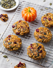 Oat cookies with cranberries on a colling rack.